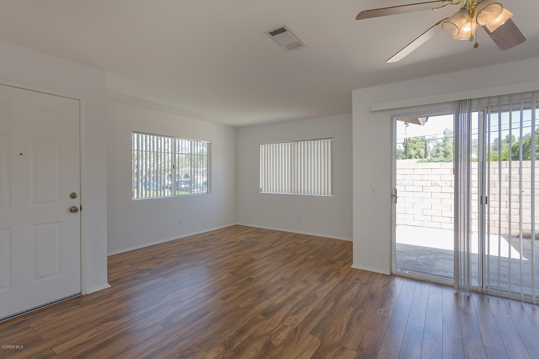 4516 Apricot Road, Unit B Simi Valley, CA 93063 - Photo 10 of 24 a view of an empty room with wooden floor and a window
