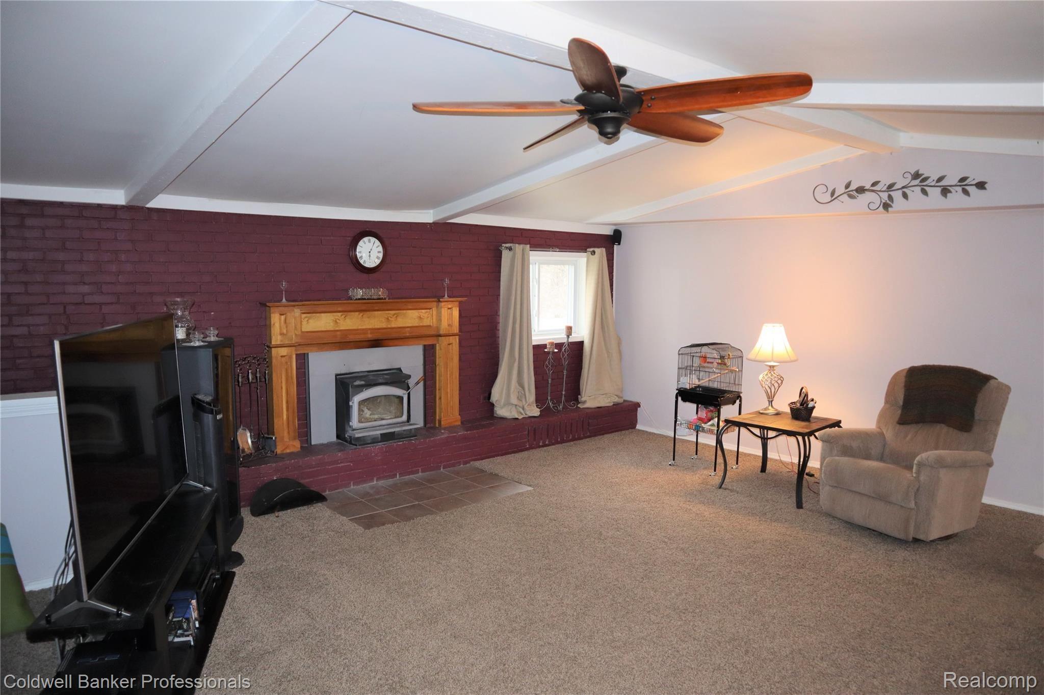 8075 South Eston Road Clarkston, MI 48348 - Photo 5 of 47 Wood stove and ceiling fan in the great room.