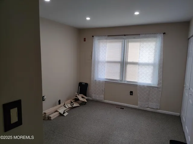 a bedroom with furniture and a baby crib