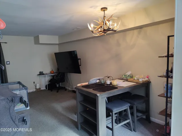 a room with a table chairs and a flat screen tv