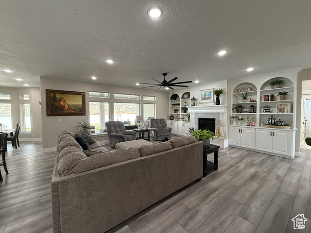 1240 West 2360 North Helper, UT 84526 - Photo 10 of 79 Living room with light wood-style floors, ceiling fan, and a textured ceiling