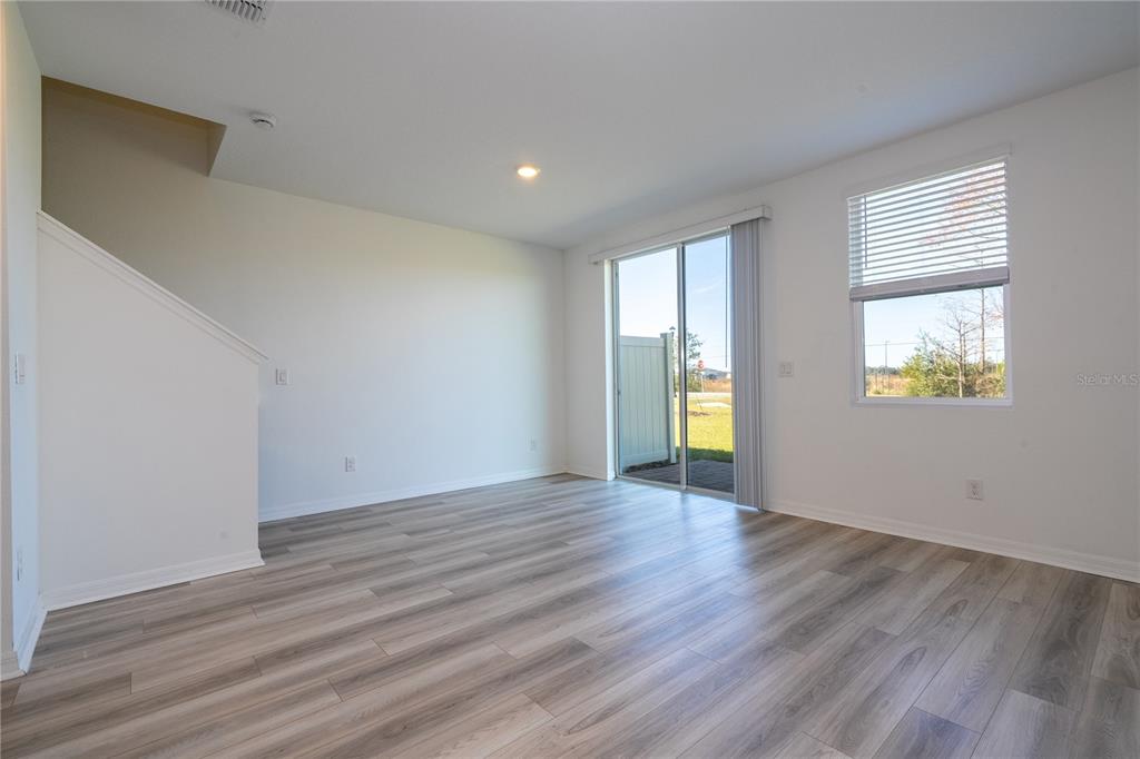 4549 Burrowing Owl Loop St. Cloud, FL 34772 - Photo 19 of 77 a view of an empty room with wooden floor and a window