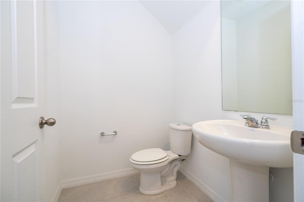 4549 Burrowing Owl Loop St. Cloud, FL 34772 - Photo 24 of 77 a bathroom with a toilet sink and mirror