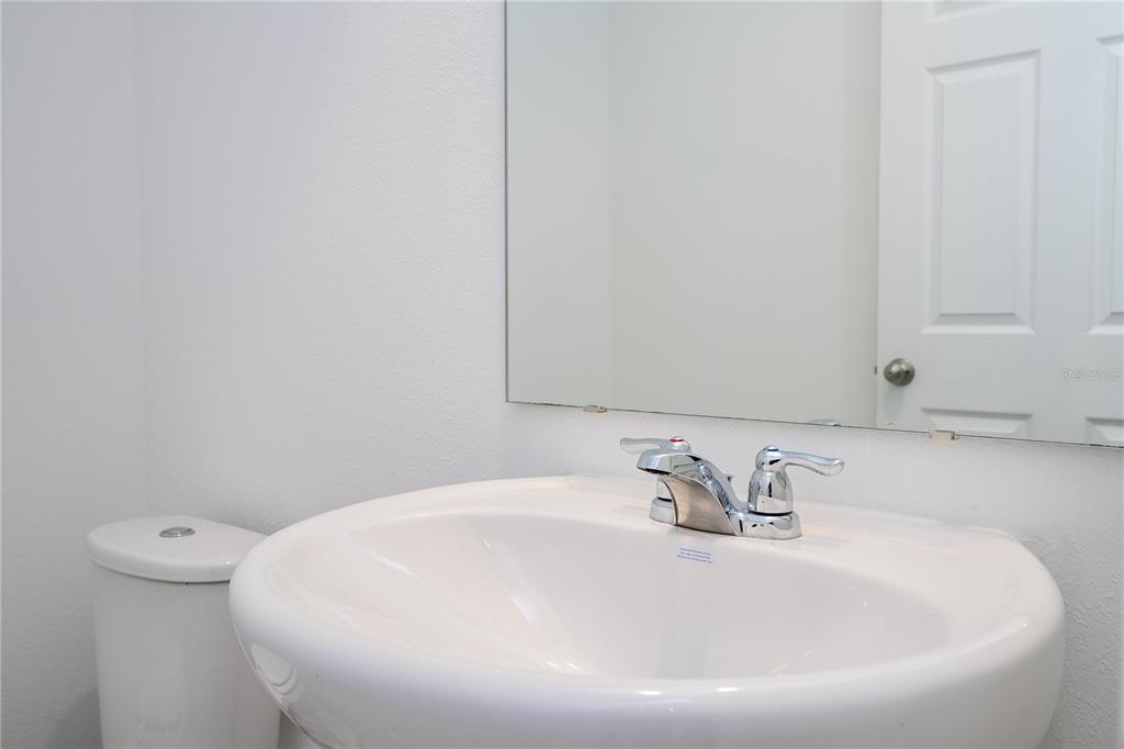 4549 Burrowing Owl Loop St. Cloud, FL 34772 - Photo 25 of 77 a bathroom with a white sink and a toilet