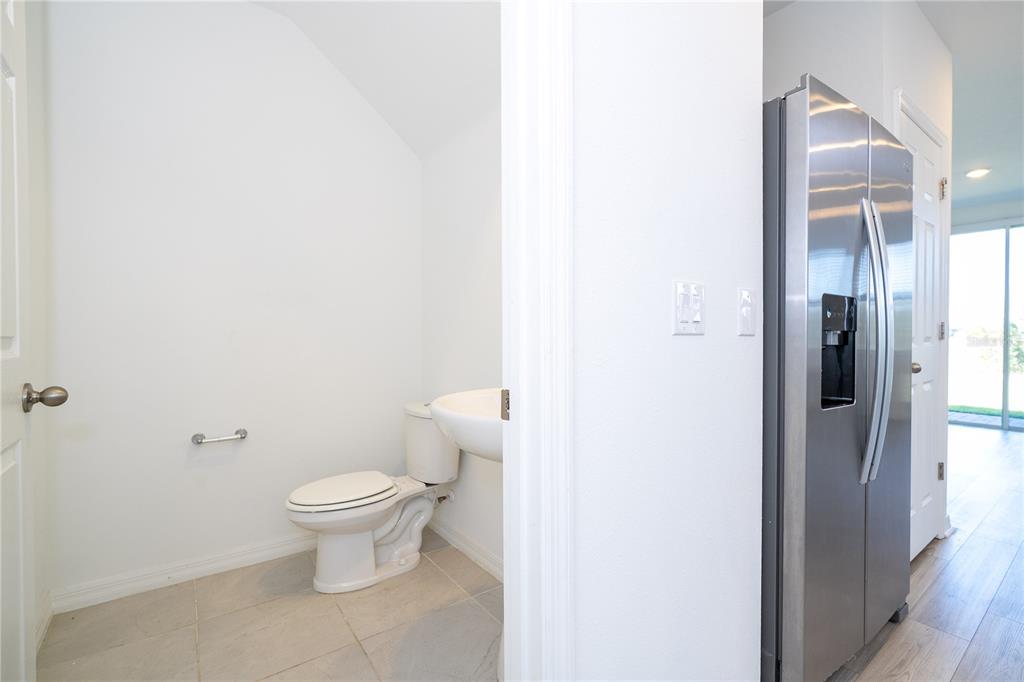 4549 Burrowing Owl Loop St. Cloud, FL 34772 - Photo 26 of 77 a bathroom with a toilet and a shower