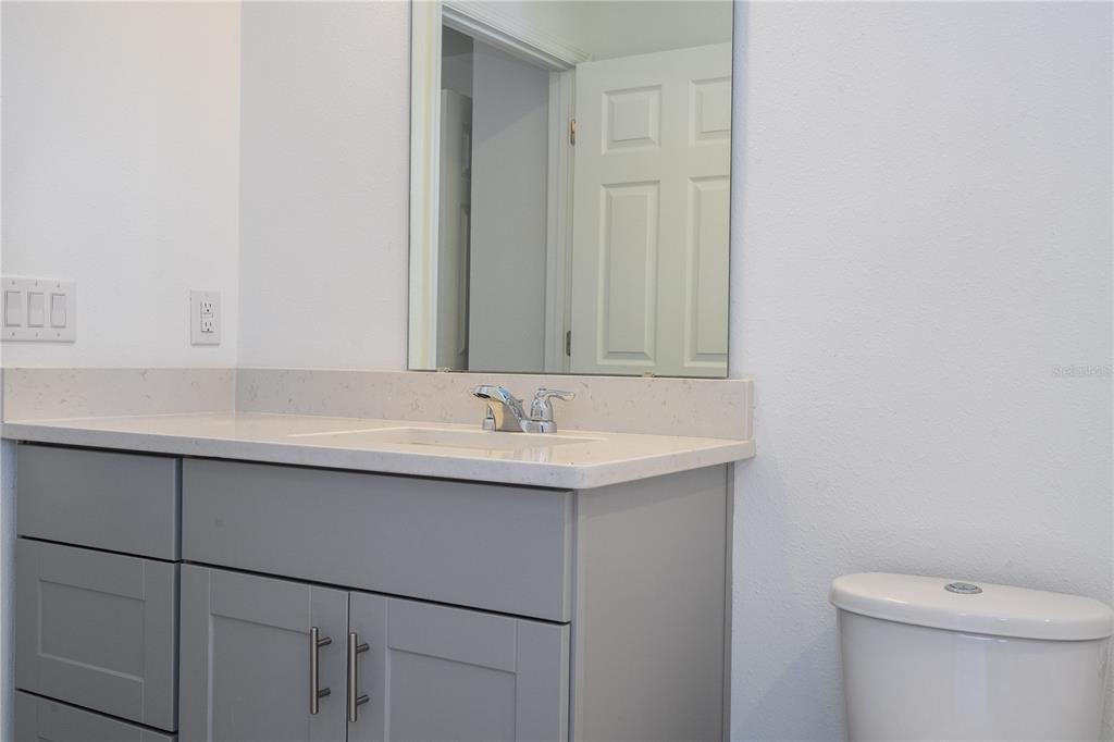 4549 Burrowing Owl Loop St. Cloud, FL 34772 - Photo 39 of 77 a bathroom with a sink and a toilet