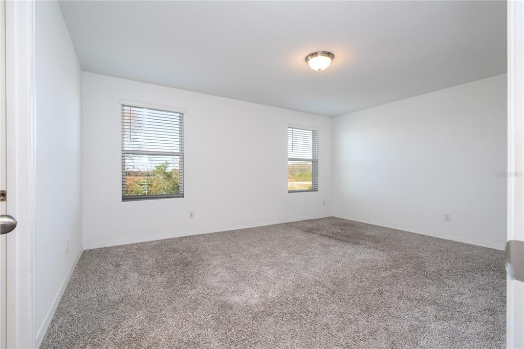 4549 Burrowing Owl Loop St. Cloud, FL 34772 - Photo 48 of 77 an empty room with windows