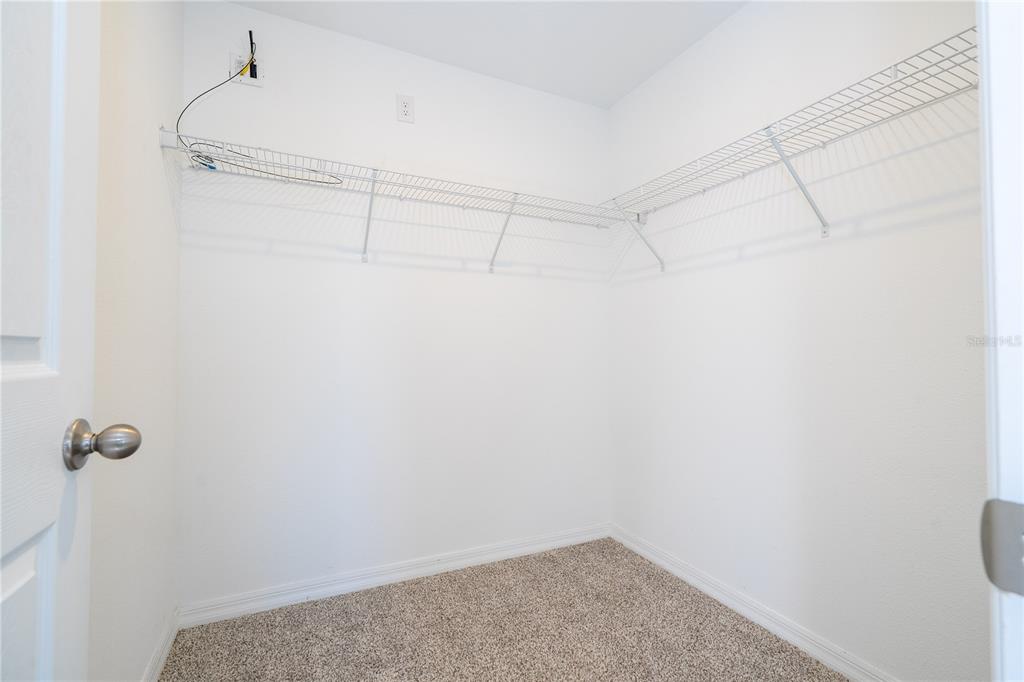 4549 Burrowing Owl Loop St. Cloud, FL 34772 - Photo 51 of 77 a view of a room with racks on the wall