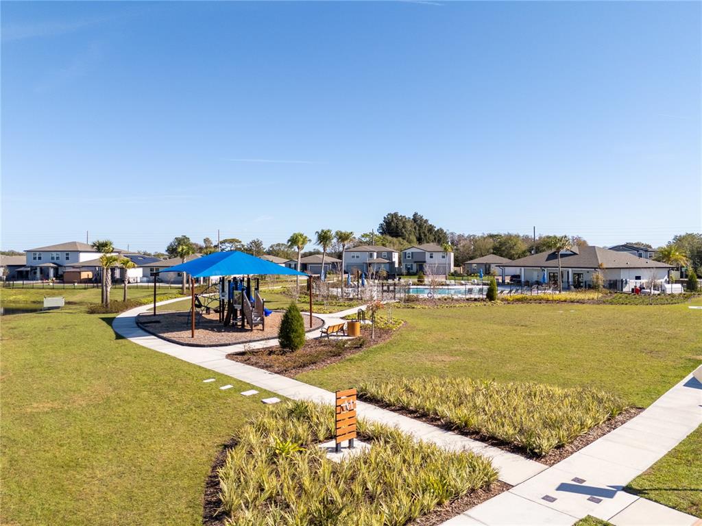 4549 Burrowing Owl Loop St. Cloud, FL 34772 - Photo 65 of 77 a view of a swimming pool with an ocean view
