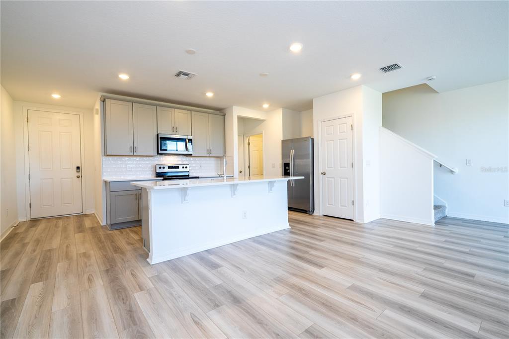 4549 Burrowing Owl Loop St. Cloud, FL 34772 - Photo 9 of 77 a view of kitchen with granite countertop cabinets and refrigerator
