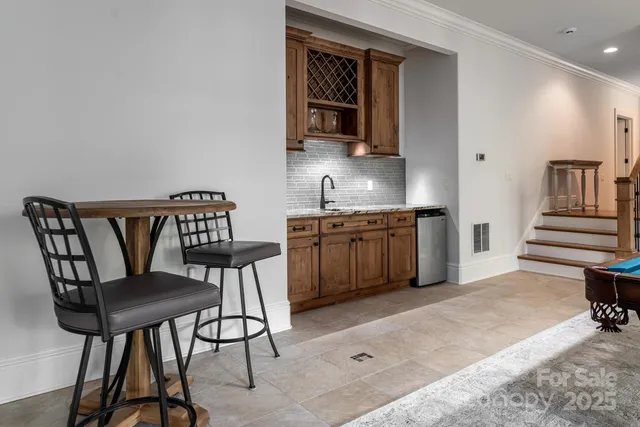 a view of a kitchen with furniture and wooden floor