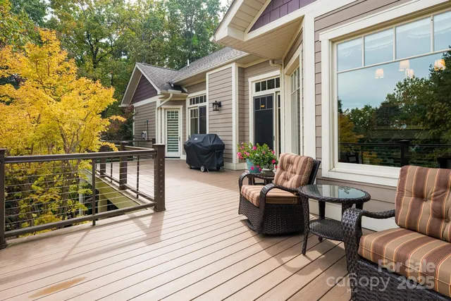a view of a deck with couches table and chairs with wooden floor