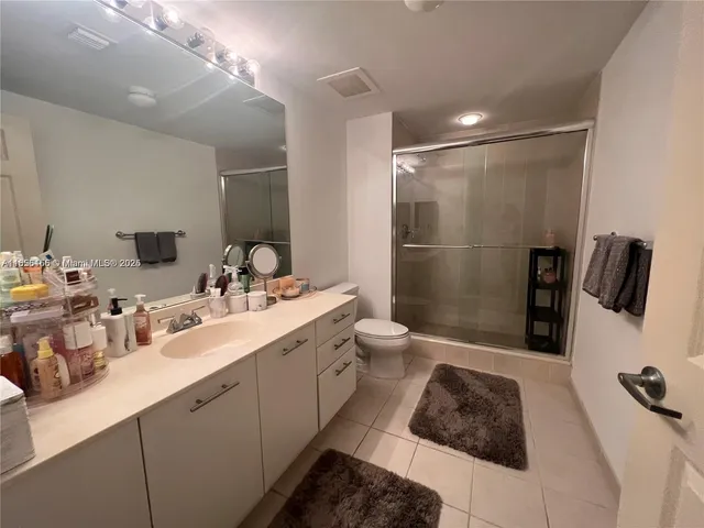 a bathroom with a double vanity sink and mirror