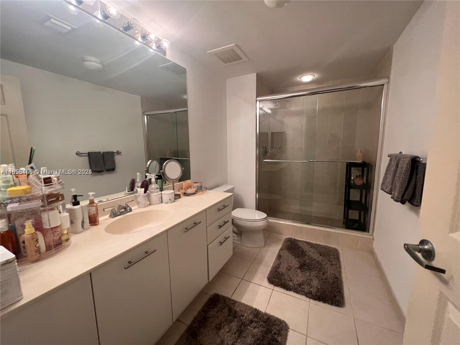 510 Northwest 84th Avenue, Unit 324 Plantation, FL 33324 - Photo 11 of 25 a bathroom with a double vanity sink and mirror