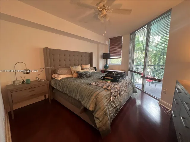 a bedroom with a bed and a tv on the dresser