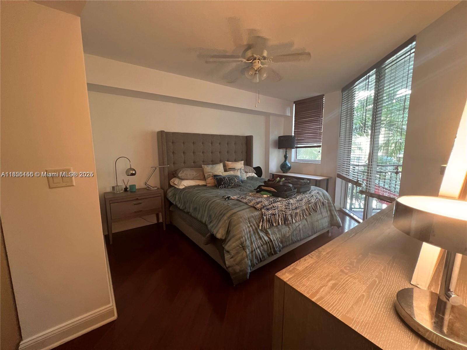 510 Northwest 84th Avenue, Unit 324 Plantation, FL 33324 - Photo 17 of 25 a bedroom with a bed and wooden floor