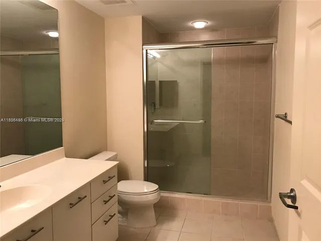 a bathroom with a shower a toilet and sink