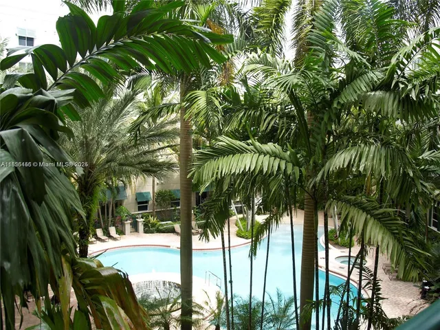 a view of backyard with swimming pool and outdoor seating