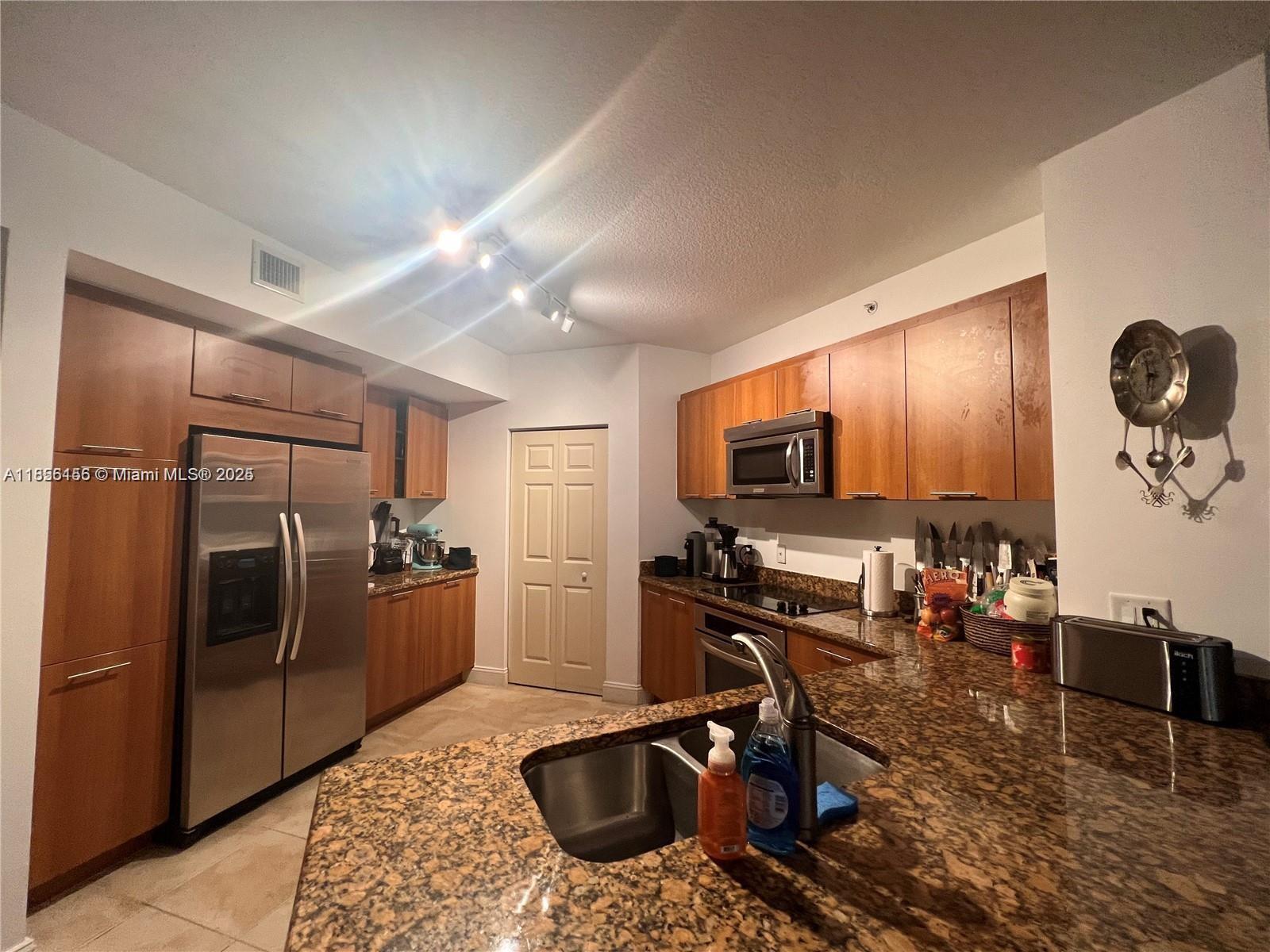 510 Northwest 84th Avenue, Unit 324 Plantation, FL 33324 - Photo 9 of 25 a kitchen with stainless steel appliances granite countertop a refrigerator and a sink