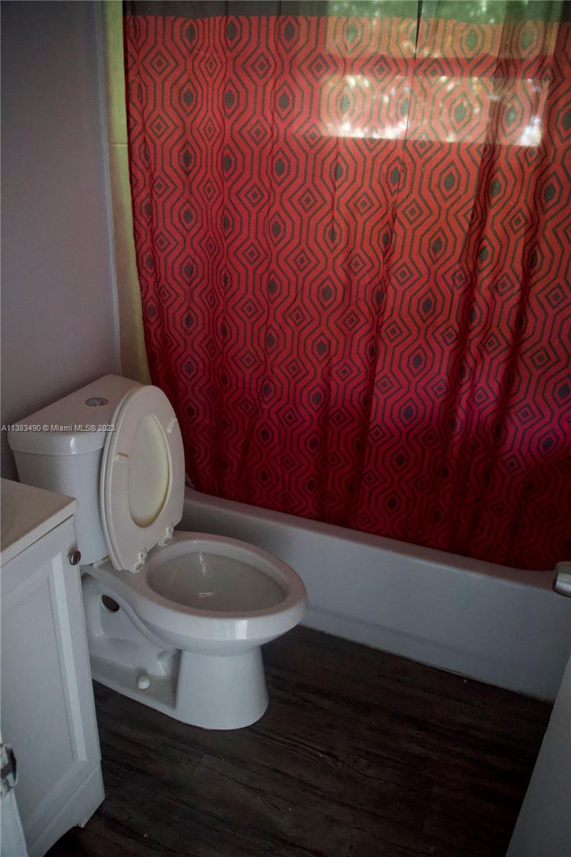 Goulds Miami, FL 33170 - Photo 9 of 10 a bathroom with a granite countertop toilet and a sink