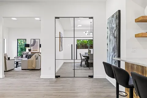 a dining room with furniture and wooden floor