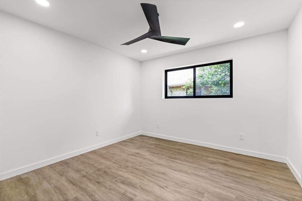 1112 Chesterton Drive Richardson, TX 75080 - Photo 23 of 31 an empty room with wooden floor and ceiling fan