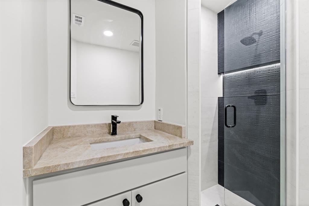 1112 Chesterton Drive Richardson, TX 75080 - Photo 24 of 31 a bathroom with a sink and a mirror
