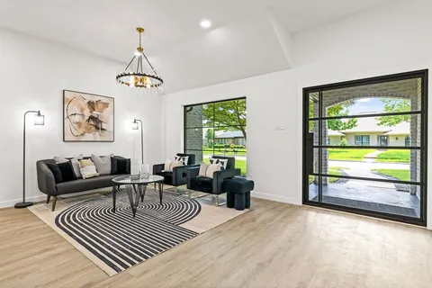 a living room with furniture and a floor to ceiling window