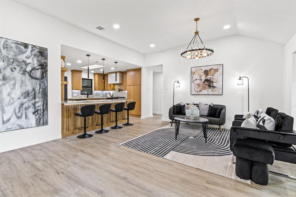 1112 Chesterton Drive Richardson, TX 75080 - Photo 10 of 31 a living room with furniture and a chandelier