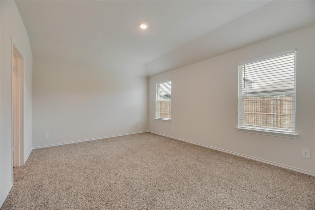 3407 Rendezvous Way Sherman, TX 75090 - Photo 12 of 17 Carpeted room featuring a vaulted ceiling with recessed lighting, two windows with blinds, and neutral wall tones
