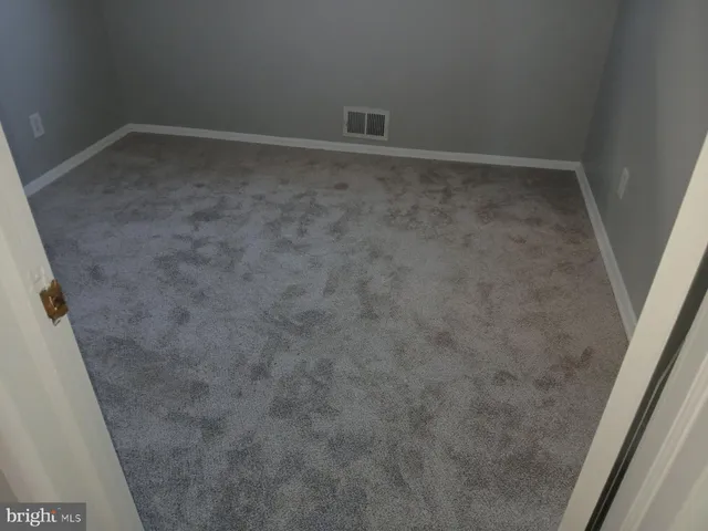 an empty room with a ceiling fan and a window