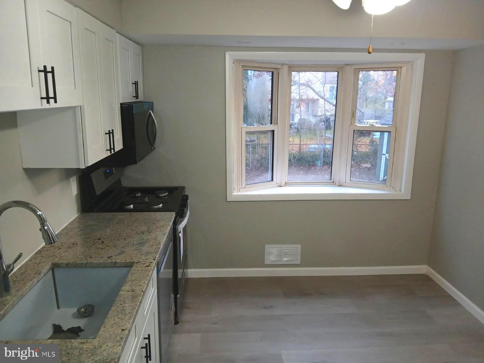930 Woodlane Road Mount Holly, NJ 08060 - Photo 5 of 26 a kitchen with a sink a window and stainless steel appliances