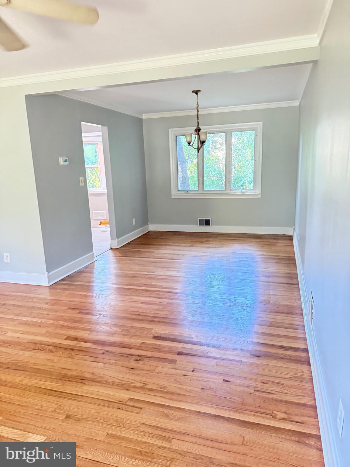 930 Woodlane Road Mount Holly, NJ 08060 - Photo 9 of 26 wooden floor in an empty room with a window
