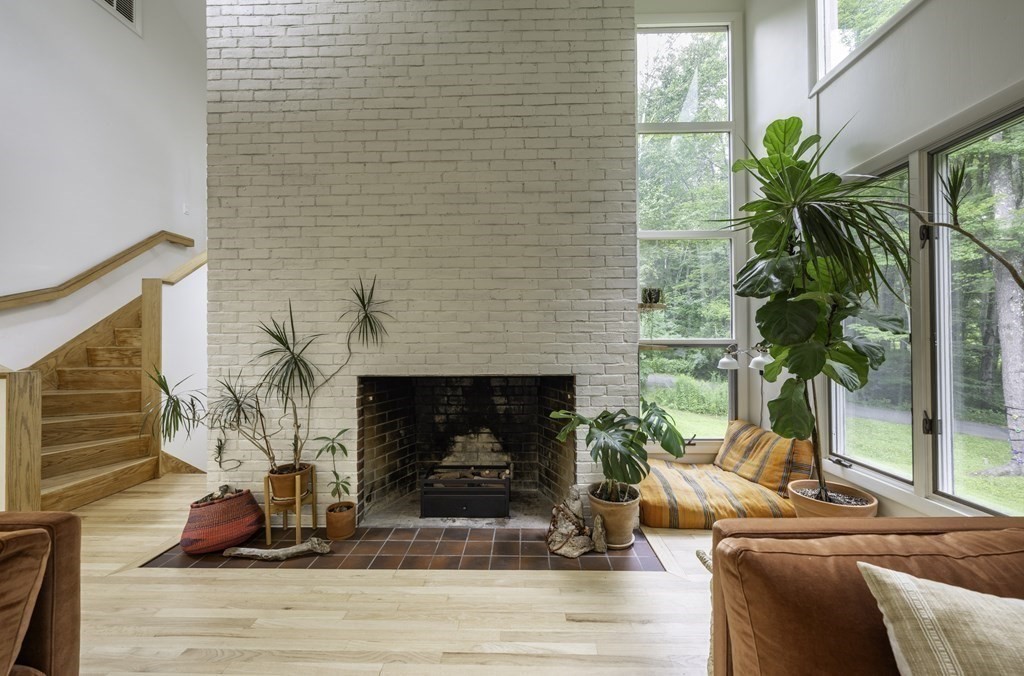 640 Kennedy Road Northampton, MA 01053 - Photo 25 of 42 a living room with furniture a potted plant and a fireplace