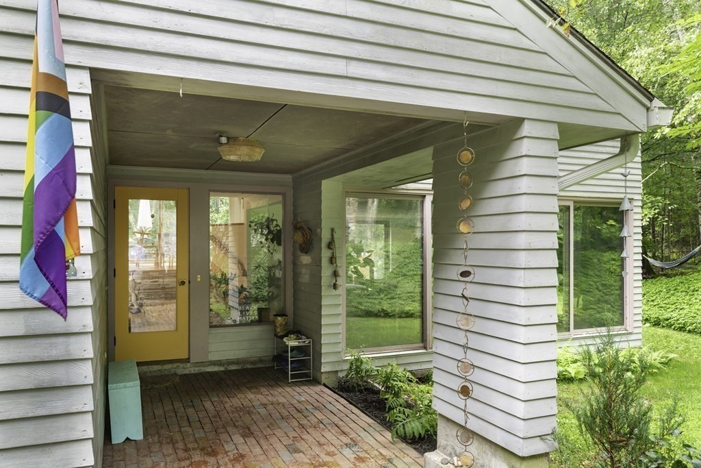 640 Kennedy Road Northampton, MA 01053 - Photo 10 of 42 a view of a porch with a floor to ceiling window and garden