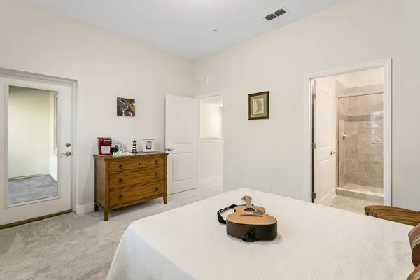 a bedroom with a bed and a dresser