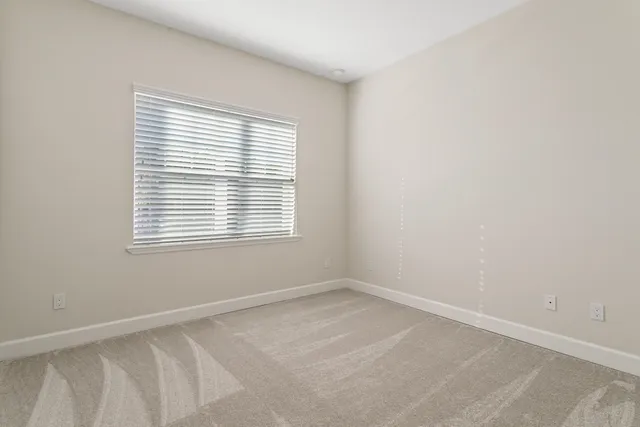 a bathroom with a granite countertop double vanity sink and mirror
