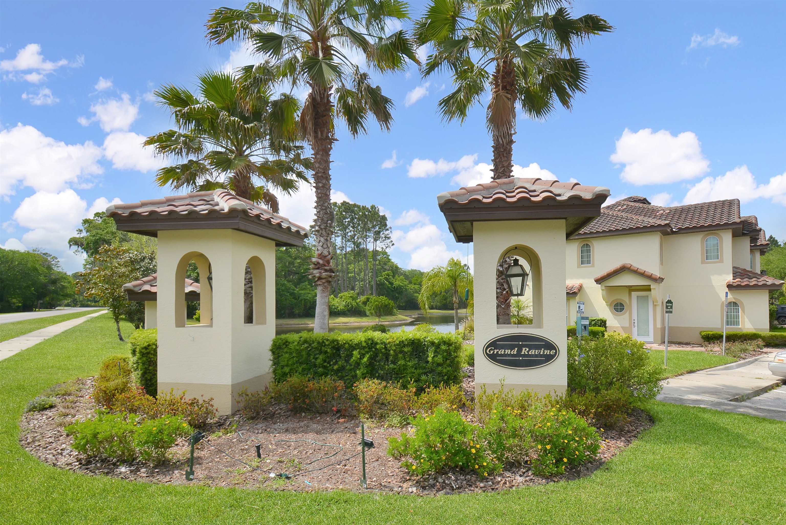 254 Grand Ravine Drive St. Augustine, FL 32086 - Photo 40 of 40 a front view of a house with a garden and trees