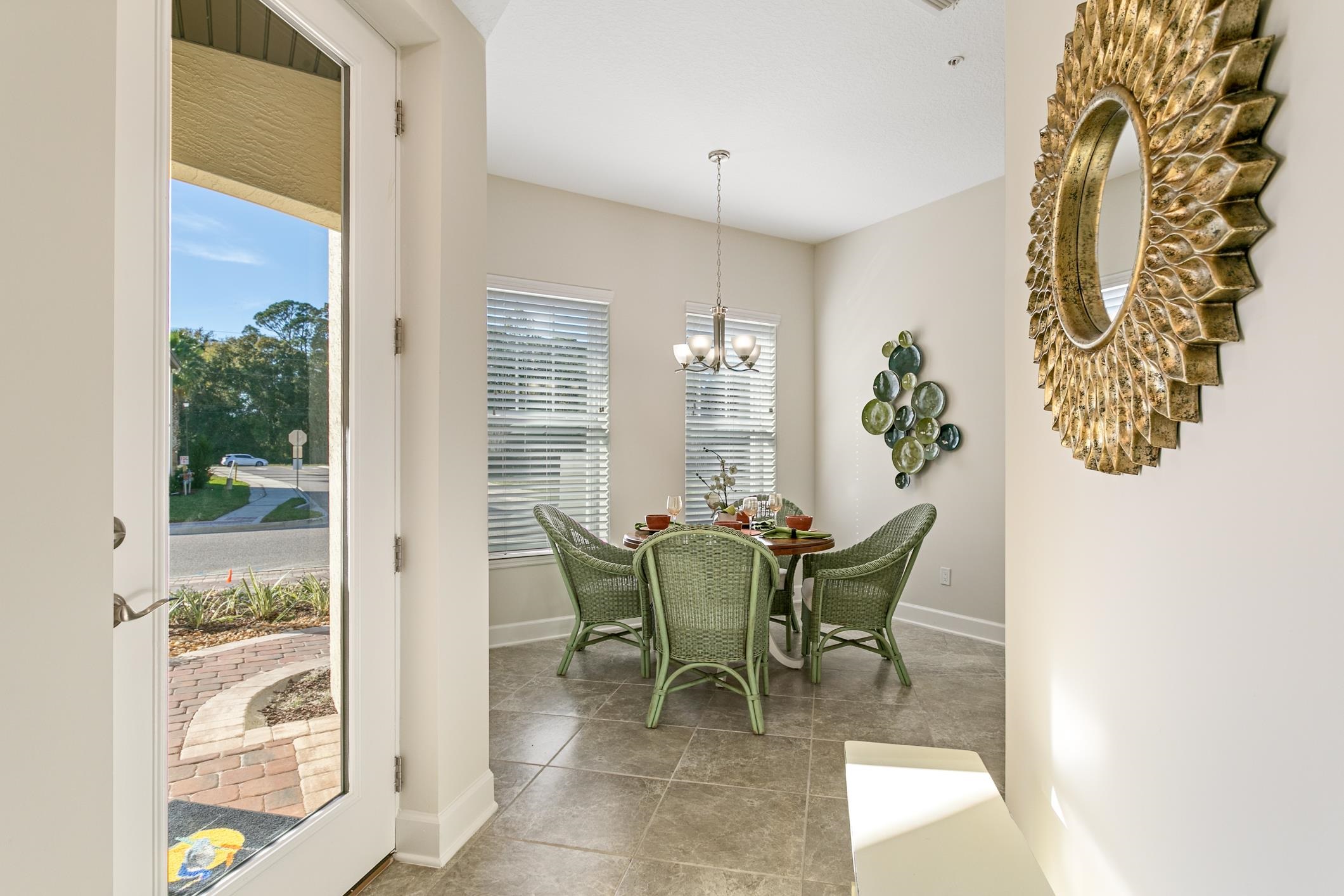 254 Grand Ravine Drive St. Augustine, FL 32086 - Photo 7 of 40 a view of a dining room with furniture and chandelier