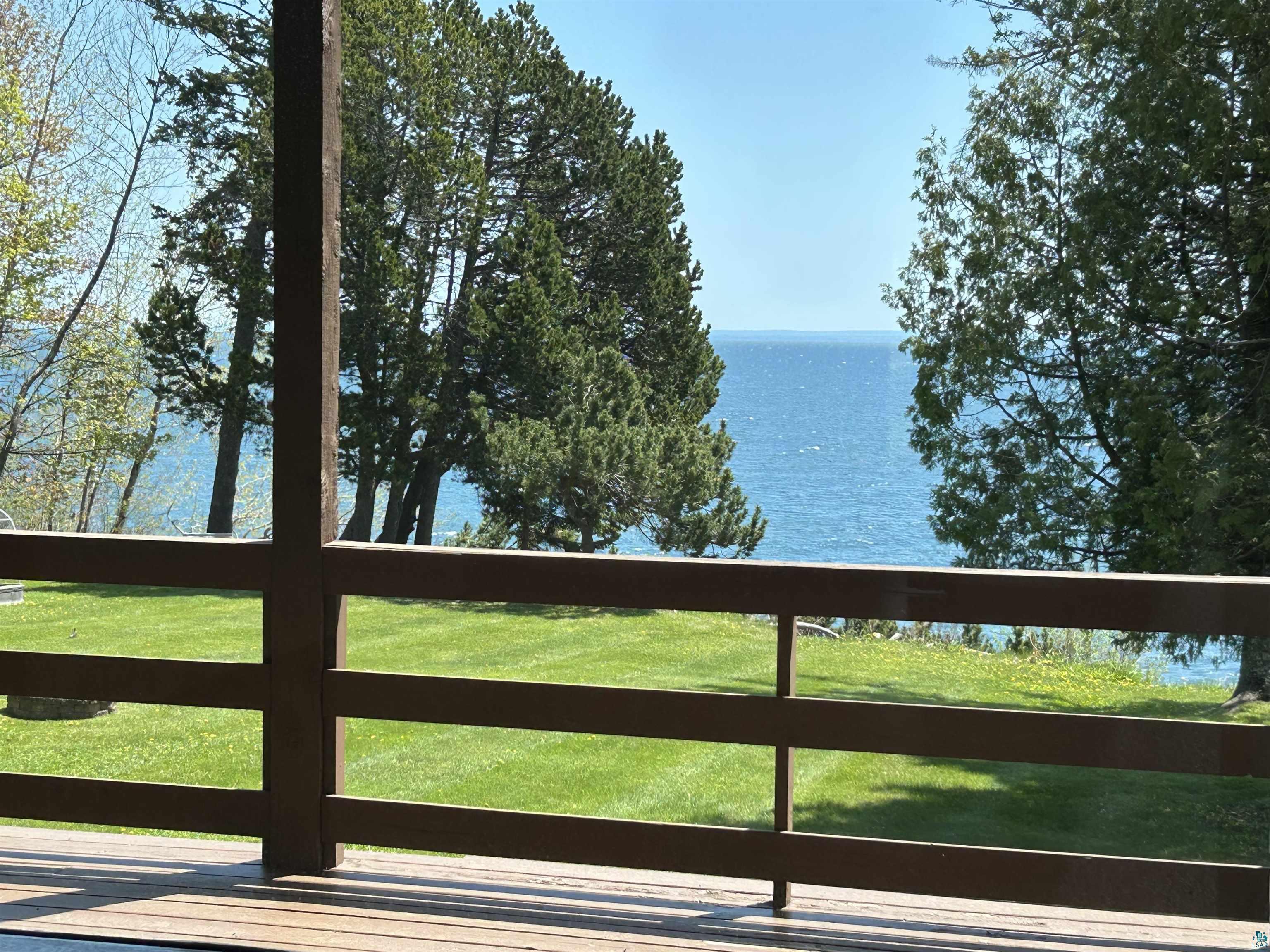 5090 London Road, Unit 1 Duluth, MN 55804 - Photo 25 of 54 Expansive water frontage visible from a private deck with wooden railing