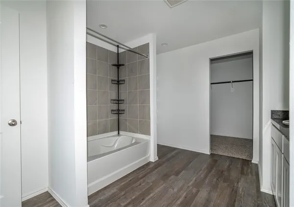 a bathroom with a bathtub and shower