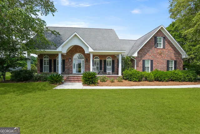 a front view of a house with garden and porch