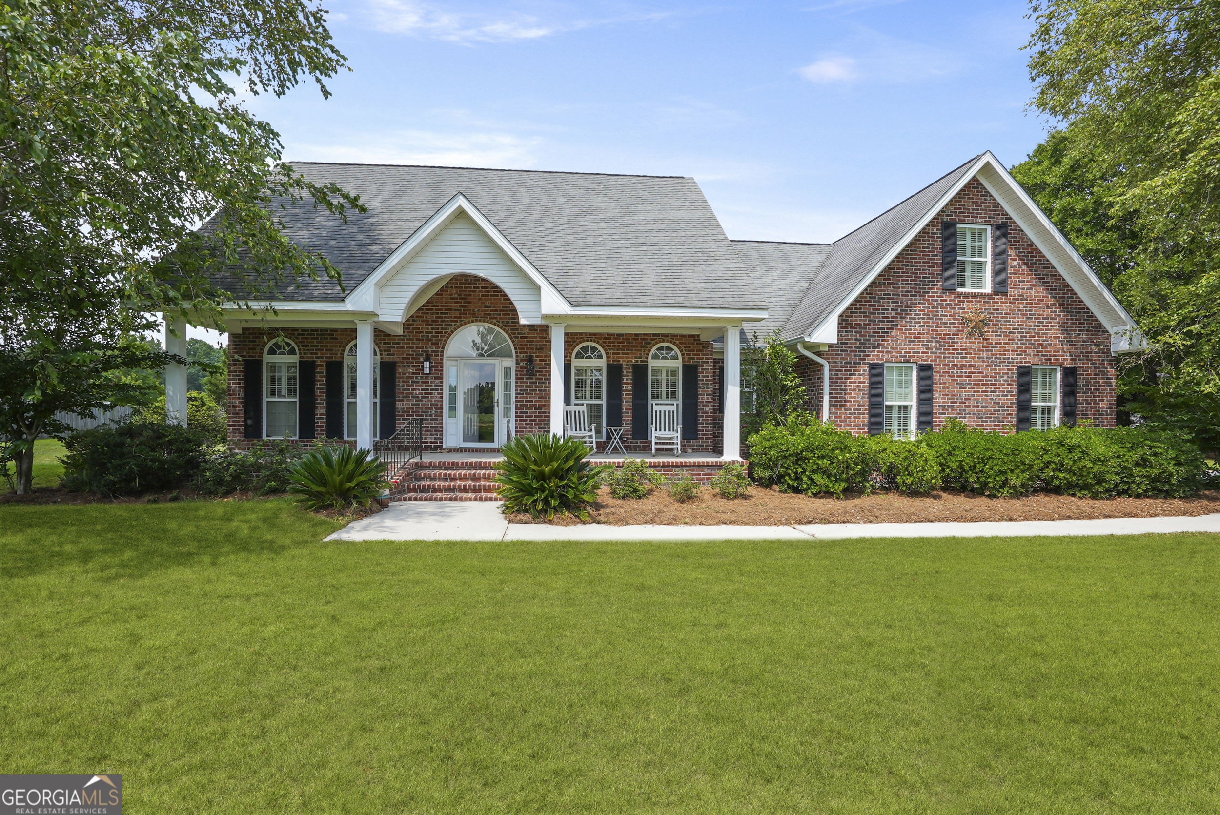 725 West Lane Street Brooklet, GA 30415 - Photo 1 of 1 a front view of a house with garden and porch