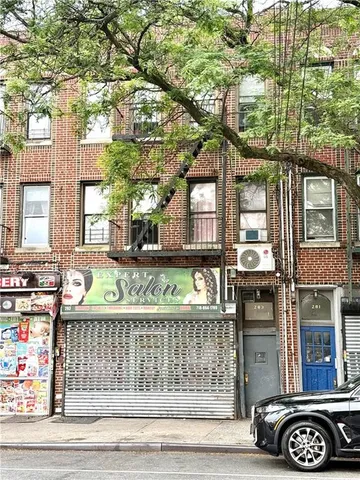 a front view of a building with parking area