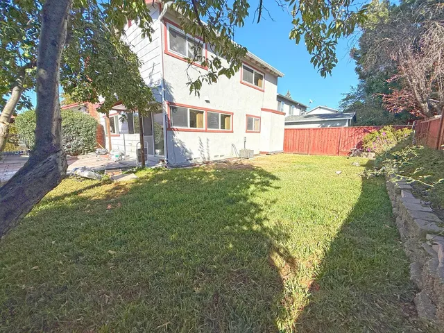 a view of a house with a backyard
