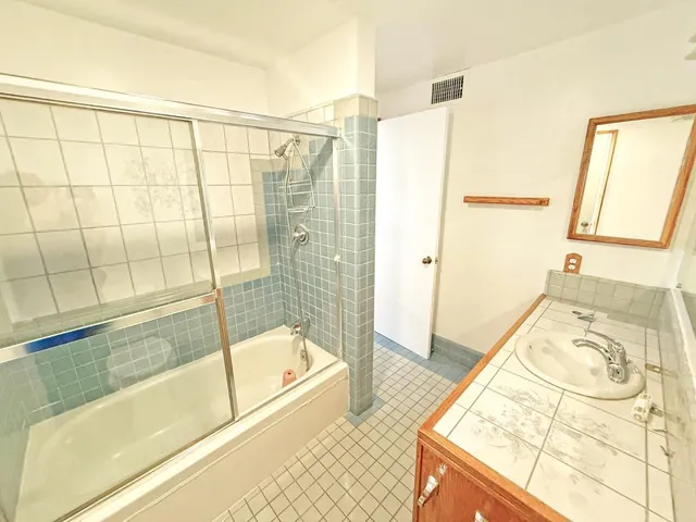 a bathroom with a tub and shower