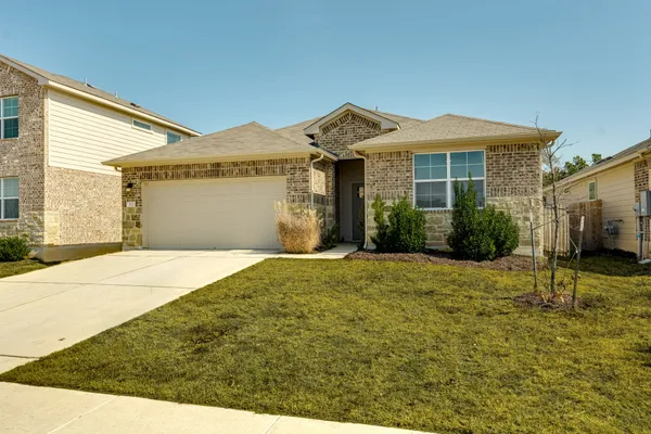 a front view of a house with a yard