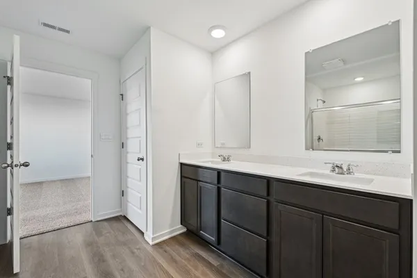 a bathroom with double sink and mirror