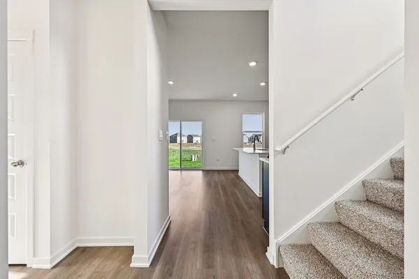 a view of entryway and hall with wooden floor