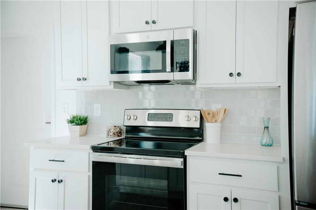 123 Mayson Avenue Northeast, Unit C Atlanta, GA 30307 - Photo 12 of 21 a kitchen with a stove and a microwave